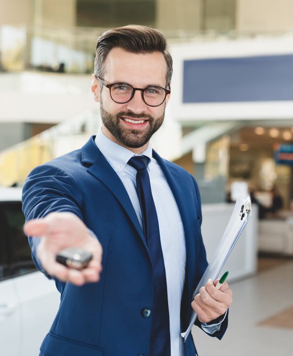 Photo of man holding hand out with car keys.